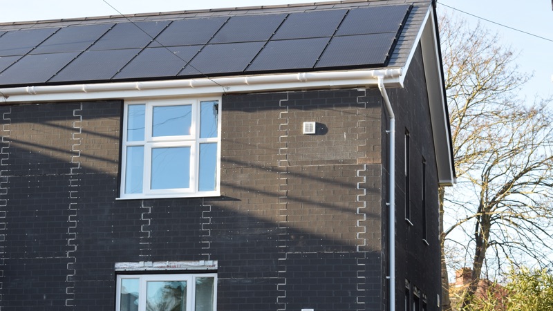 Exeter net zero carbon housing pilot project external cladding and solar roof closeup