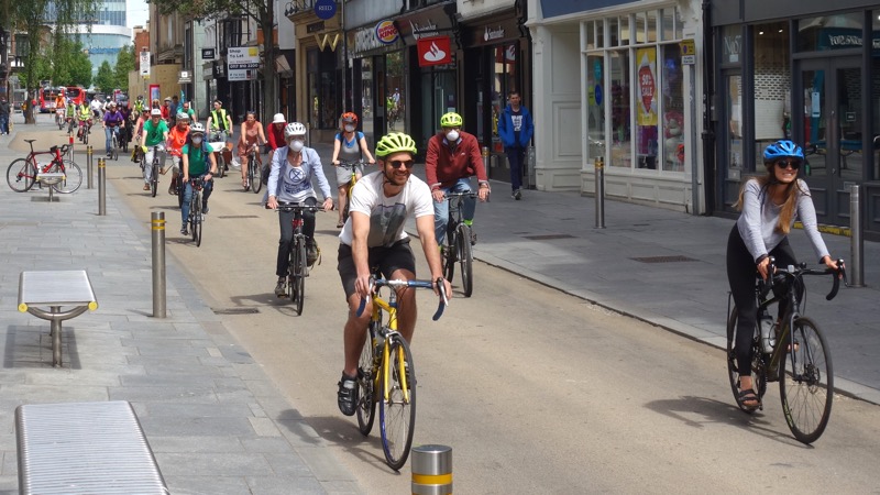 Cyclists demonstrate socially distanced cycling on Exeter High Street