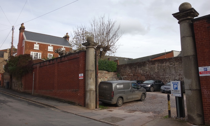 Exeter city wall seen through Northernhay Street car park marbleworks gate pillars