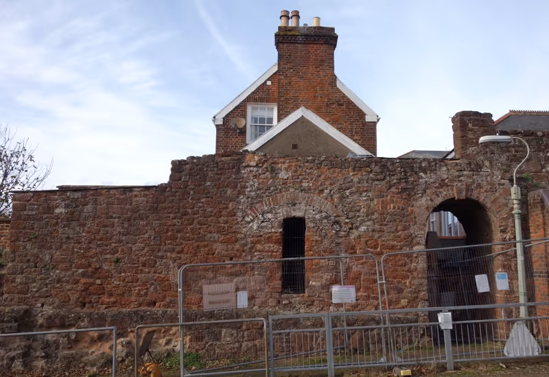 Maddocks Row arch in Exeter city wall adjoining historic housing on Northernhay Street