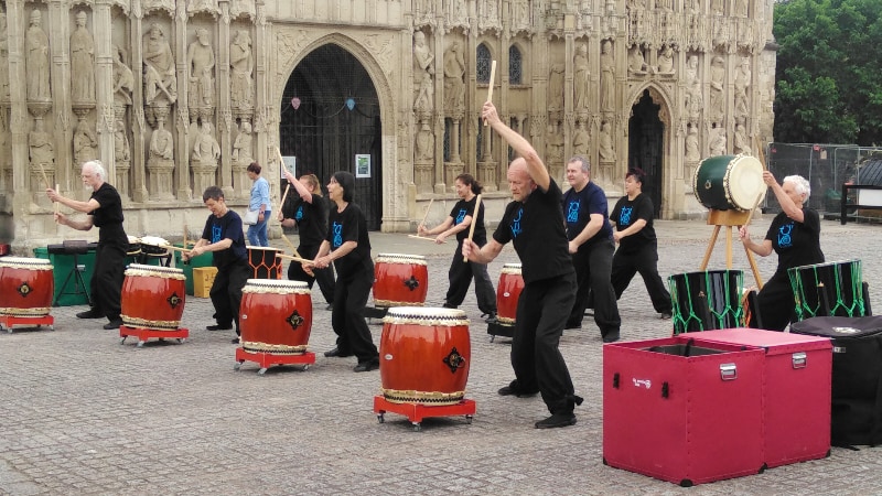 Japanese ceremonial drummers Tano Taiko playing beside Exeter Cathedral