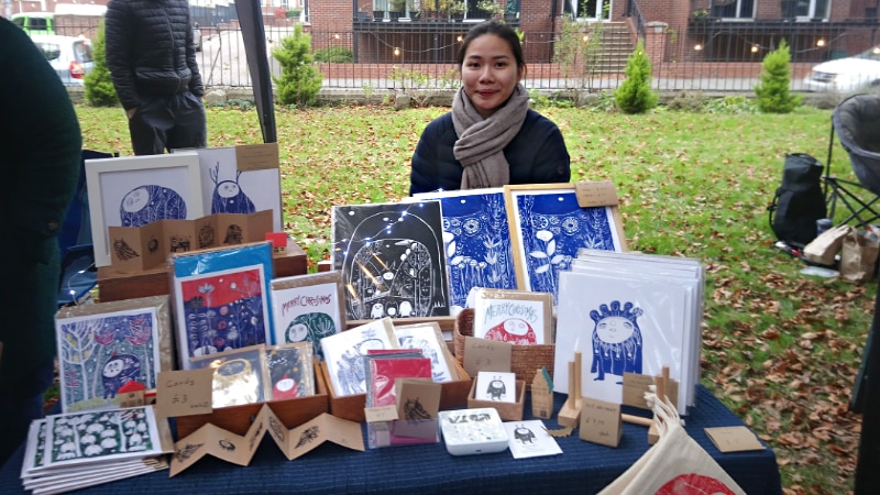 First time trader illustrator Marson Wu sitting at her stall