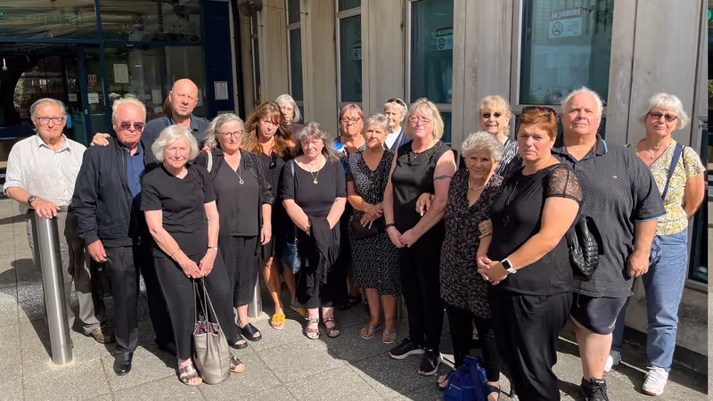 Save Northbrook Pool campaigners dressed in black outside Exeter City Council's offices on 24 June 2025