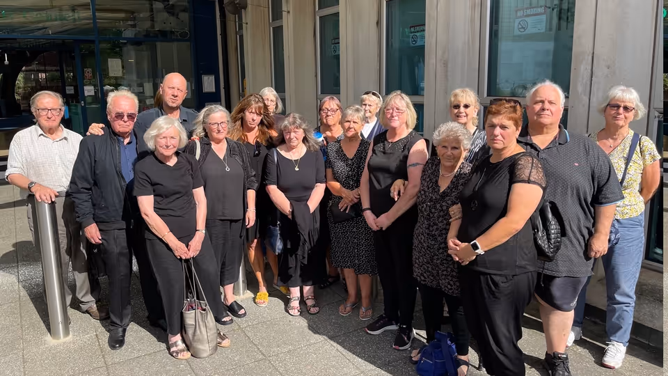 Save Northbrook Pool campaigners dressed in black outside Exeter City Council's offices on 24 June 2025